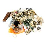 A large bag of various items of costume jewellery to include brooches, silver, fashion watches,