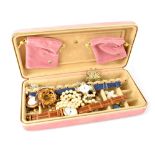 A pink travel jewellery box with some costume jewellery to include two fashion watches,