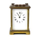 An SF brass carriage clock, the white enamelled dial set with Roman numerals, height 11cm.
