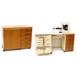 A modern sewing cabinet with fitted interior and a 'Serenade 30' Singer sewing machine,