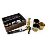 A small brass and black lacquer students' microscope, a quantity of various lenses,