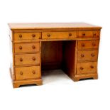 An early 20th century pine nine-drawer twin pedestal desk, length 121cm, depth 59cm, height 76cm.