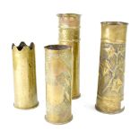 Four WWI and later brass artillery shell casings, later embellished as Trench Art,