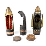 Two ballistic artillery shells with mechanical timer, with cut-away front sections,