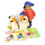 A Paddington Bear soft toy dressing in blue felt sou'wester and red duffle coat with blue Dunlop