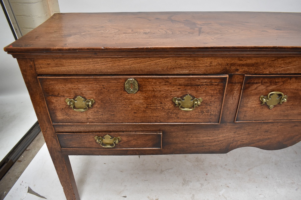 A George III oak and elm dresser base, the moulded rectangular top above three drawers with two - Image 3 of 6