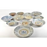 Twelve Chinese Song dynasty provincial earthenware bowls, the majority with stylised underglaze blue