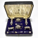 ADIE BROTHERS & ELKINGTON: a cased George V hallmarked silver six piece condiment set, with four