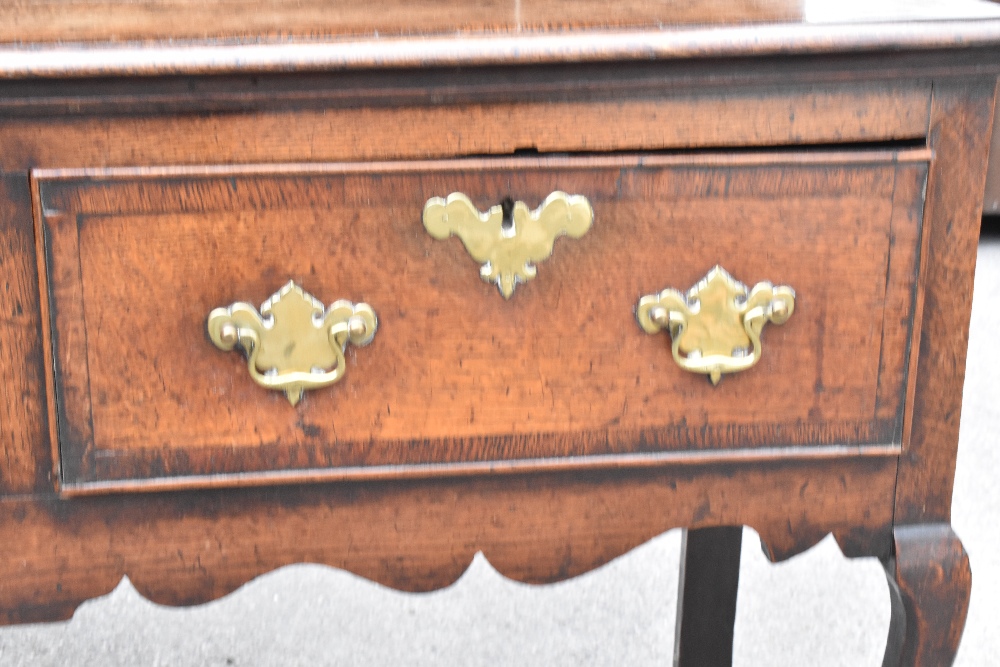 An 18th century oak dresser of low proportions, the plate rack back with carved and moulded - Image 4 of 6