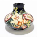 MOORCROFT; a squat tubeline floral decorated vase on navy ground, printed 'Golden Jubilee 2002',