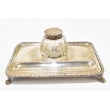 S W SMITH & CO; a George V hallmarked silver inkstand with single clear glass inkwell and pen
