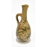 MARTIN BROTHERS; an art pottery jug of bulbous form with elongated neck, with floral detail,