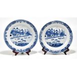 A pair of 18th century Chinese porcelain chargers decorated in underglaze blue with river