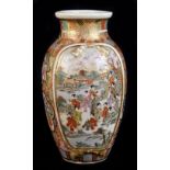 A small Japanese Satsuma vase, decorated with opposing raised panels depicting figures in a