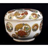 A Japanese Satsuma circular box and cover, decorated throughout with floral roundels on a cream