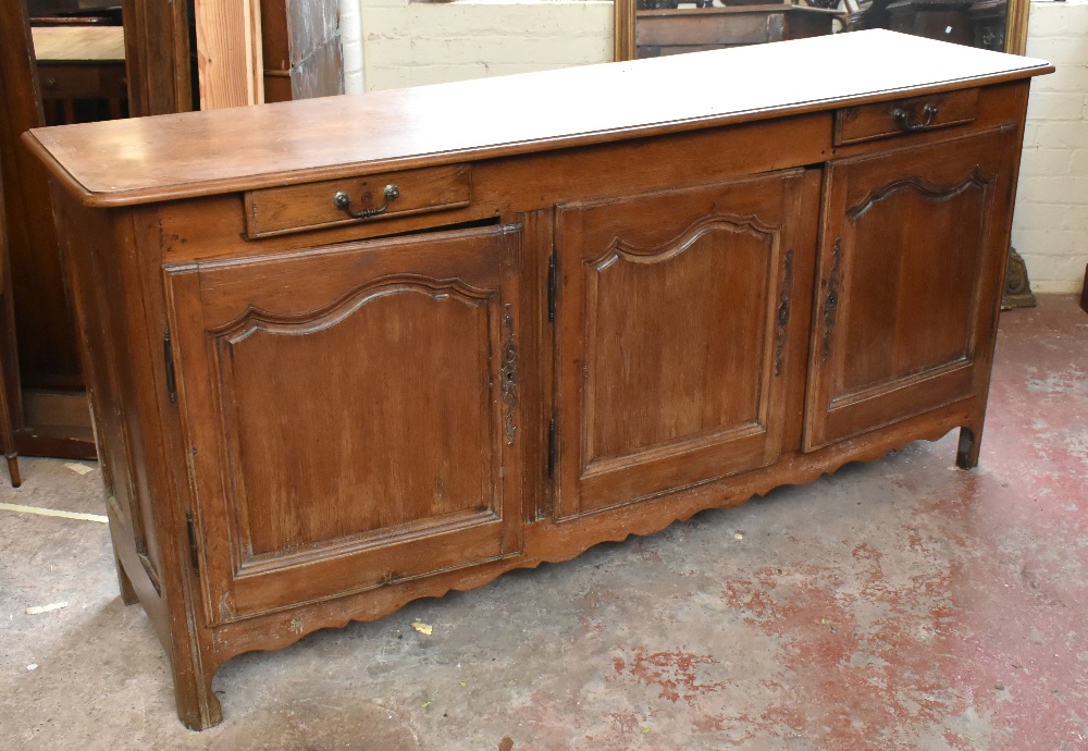 A late 19th century French oak dresser base with moulded rectangular top above two shallow frieze