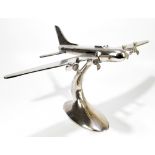 A large chromed tabletop model aeroplane on oval base, height 42cm, width 80cm, depth 47cm.