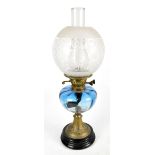 A late 19th/early 20th century oil lamp with etched glass shade, clear chimney and blue glass