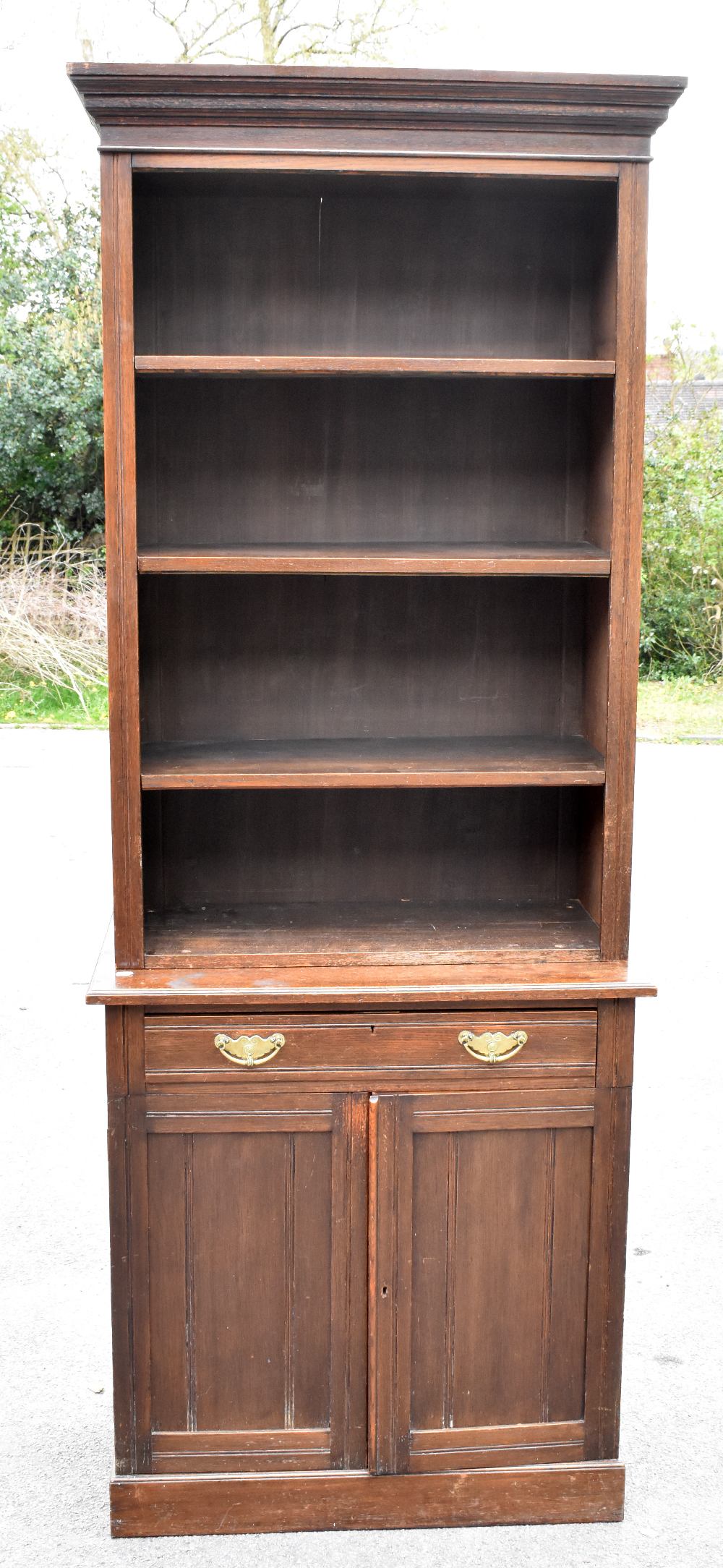 A Victorian oak bookcase, the upper section with three adjustable shelves, the base section with