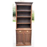 A Victorian oak bookcase, the upper section with three adjustable shelves, the base section with