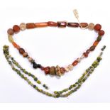 A circa 8th century AD Middle Eastern necklace comprised of carved beads including carnelian,