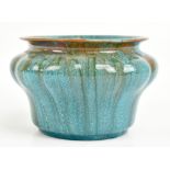 ROYAL LANCASTRIAN; a squat vase with relief decoration, decorated in a turquoise/brown glaze,