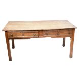 A late 19th century French oak two drawer writing table raised on chamfered square sectioned