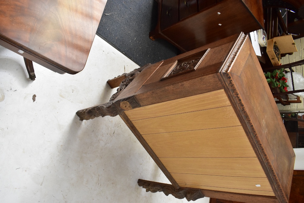 A late 19th century carved oak Black Forest-style side cabinet, the twin doors decorated with - Image 4 of 4