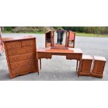 A modern mahogany finished five piece bedroom suite comprising a chest of two short over three