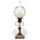 An early 20th century marble and cast metal oil lamp with clear glass reservoir and frosted shade,