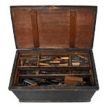 An old stained pine tool chest housing a large collection of assorted antique and later tools.
