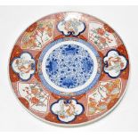 An early 20th century Japanese Imari porcelain wall charger, decorated with various panels depicting