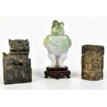 A carved grey soapstone shishi, height 8cm, a carved hardstone Chinese urn and cover upon a wooden