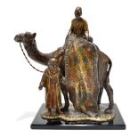 IN THE MANNER OF BERGMAN; an early 20th century bronzed spelter figure group, 'The Rug Seller',
