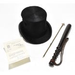 An ebonised police truncheon, together with a silk top hat by Woodrow of Manchester, and taper