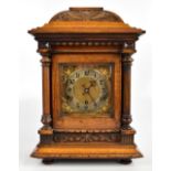 KIENZLE UHREN; a German mahogany cased mantel clock with carved Art Nouveau-style decoration to