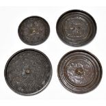 Four Chinese bronze circular mirrors, each with cast relief decoration, diameter of largest