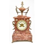 A late 19th century French rouge marble mantel clock with gilt metal twin handles and mounts, on