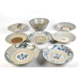 Eight Chinese Song dynasty provincial earthenware bowls with stylised underglaze blue decoration,