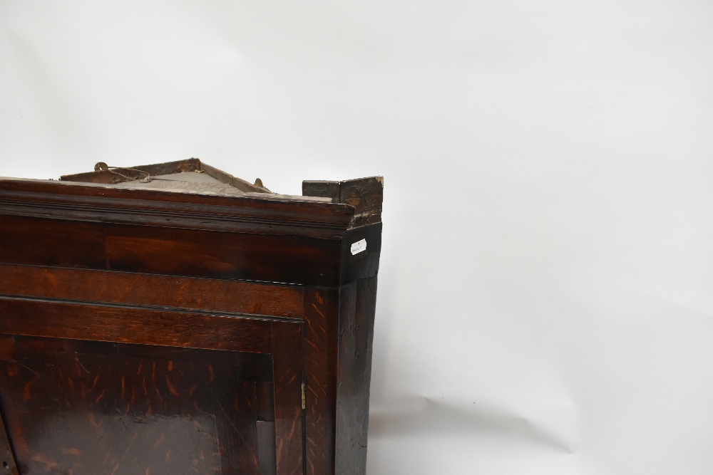 An 18th century oak flat fronted hanging corner cupboard, the single panelled door above three - Image 3 of 4