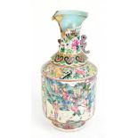 A 19th century Chinese Canton Famille Rose enamel decorated vase featuring panelled scene of figures