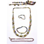 Three necklaces and two bracelets comprised of ancient beads including faience, iridescent glass,