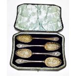 WALKER & HALL; a cased set of four Victorian hallmarked silver berry spoons, with cast decoration to