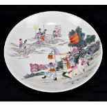 A late 19th century Chinese charger decorated with figures in clouds and further figures with a