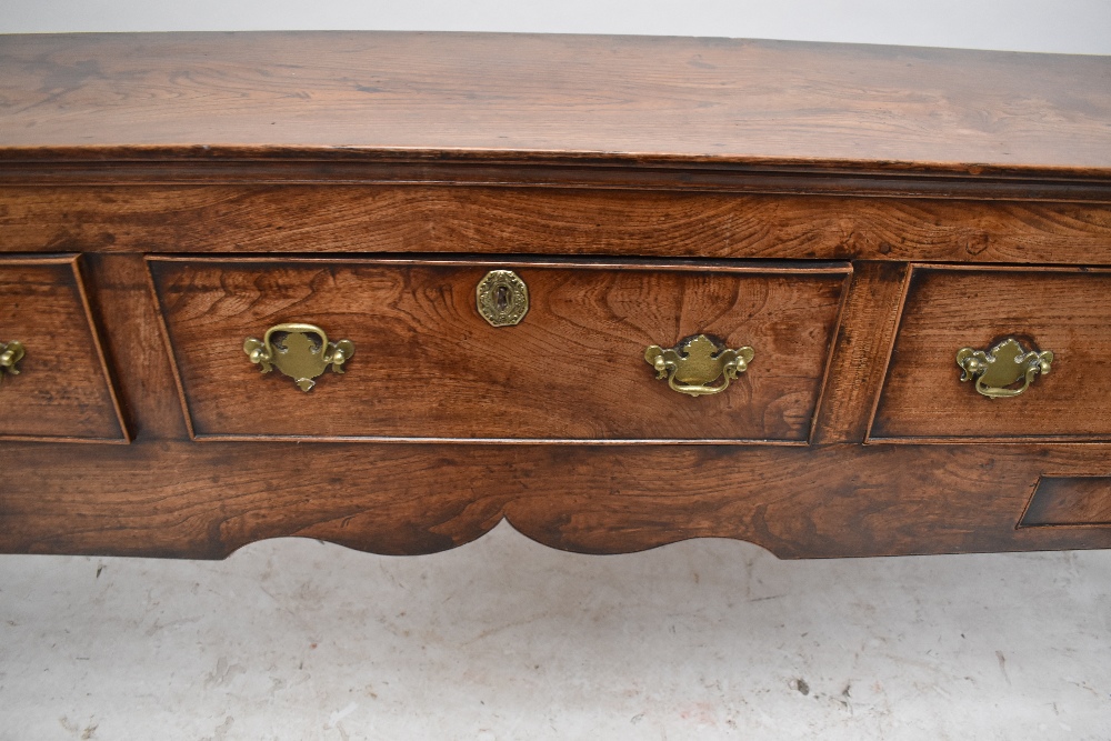 A George III oak and elm dresser base, the moulded rectangular top above three drawers with two - Image 4 of 6