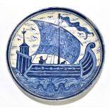 BUSHEY HEATH; an art pottery dish decorated with a serpent below a galleon on stormy seas,