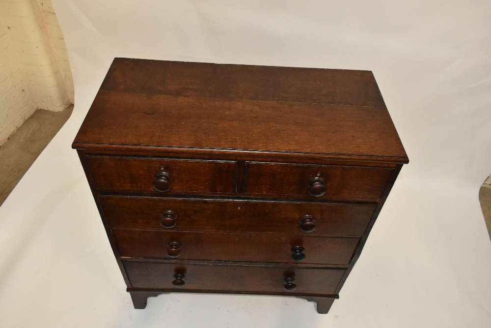 A 19th century oak chest of two short over three long drawers, raised on bracket feet, length - Image 2 of 2