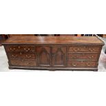 A good and large early 19th century oak and mahogany crossbanded North Country dresser base with two