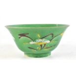 An early 18th century Chinese green glazed bowl with single leaf to the interior and with stylised