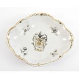 An 18th century Chinese export porcelain armorial shaped dish painted in gilt and en grisaille,